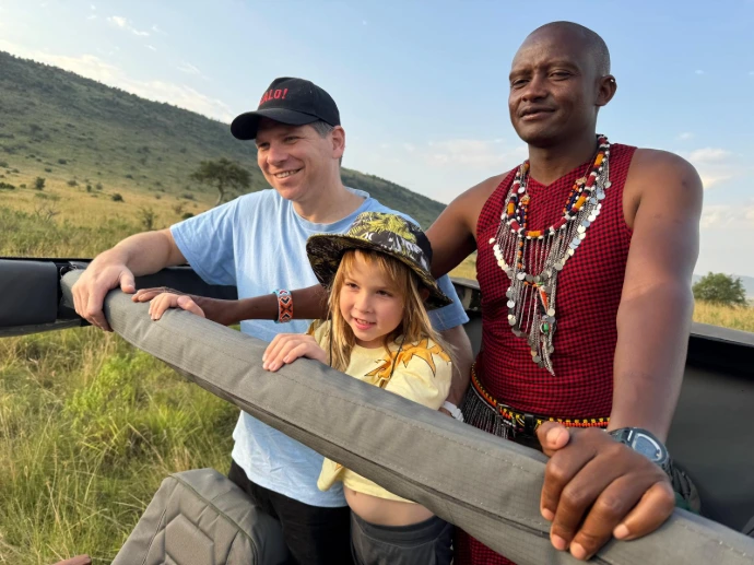 Tourists enjoying a guided safari experience in Maasai Mara